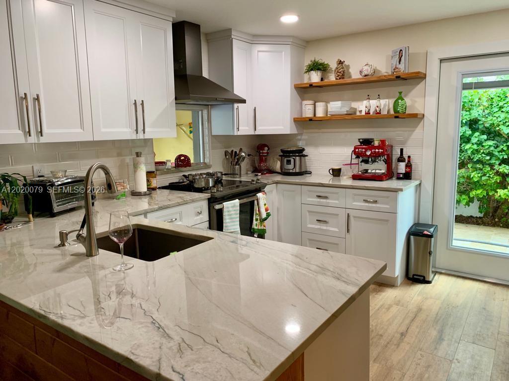 13611 Southwest 103rd Street Miami, FL 33176 - Photo 4 of 22 a kitchen with stainless steel appliances granite countertop a sink a stove and a refrigerator