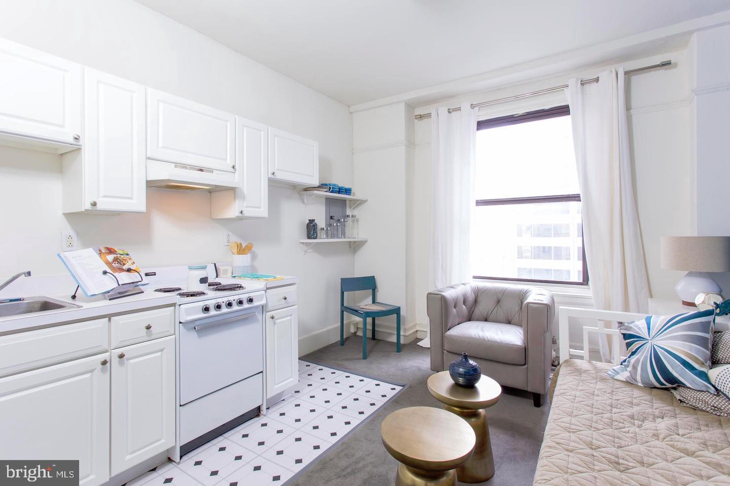 1229 Chestnut Street, Unit 322 Philadelphia, PA 19107 - Photo 12 of 21 a kitchen with a sink stove and white cabinets