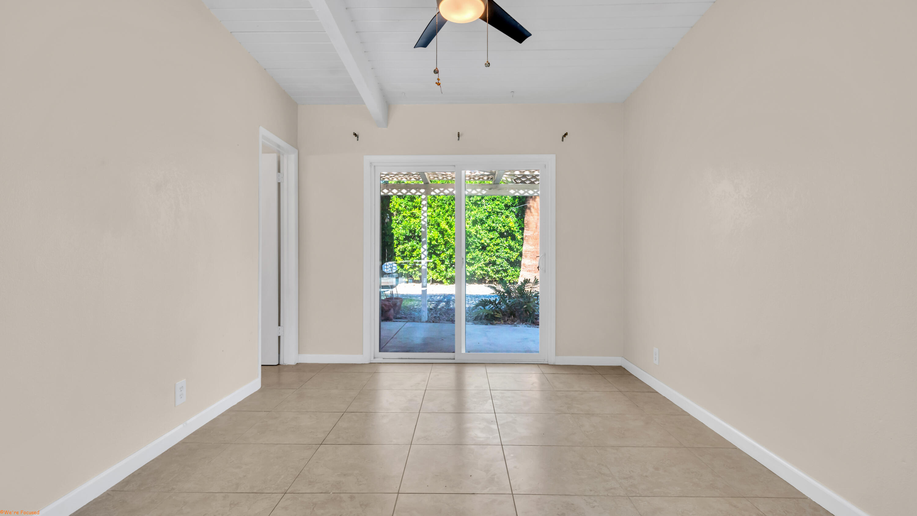 2272 North Starr Road Palm Springs, CA 92262 - Photo 26 of 38 an empty room with floor to ceiling window and ceiling fan