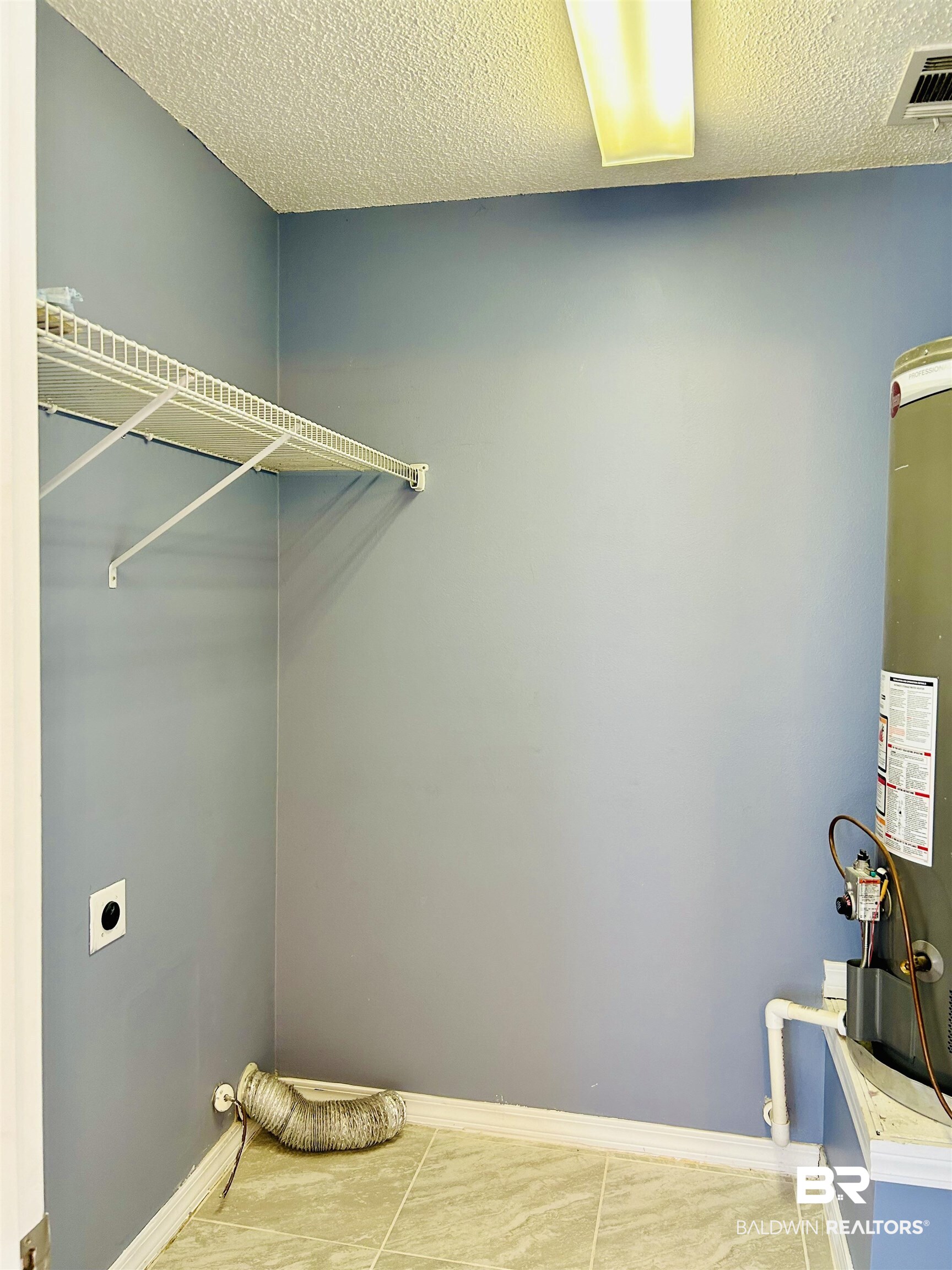 919 Parliament Court Mobile, AL 36695 - Photo 10 of 19 Laundry area featuring hookup for an electric dryer, water heater, and a textured ceiling