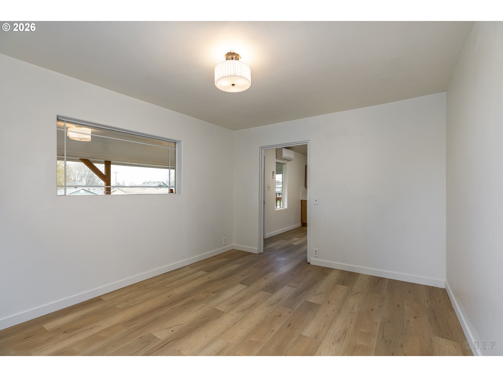 415 North 9th Street St. Helens, OR 97051 - Photo 5 of 21 a view of an empty room with wooden floor and a window