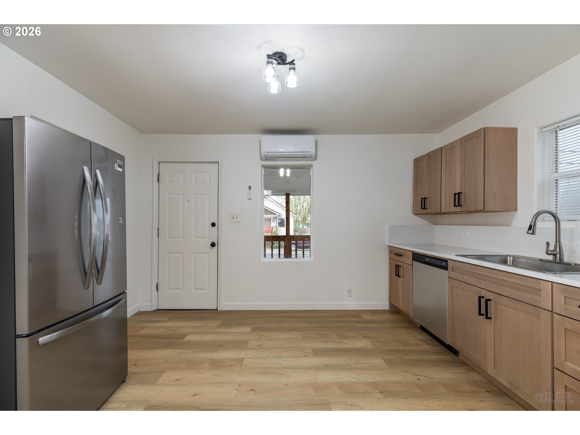 415 North 9th Street St. Helens, OR 97051 - Photo 6 of 21 a kitchen with stainless steel appliances granite countertop a refrigerator a sink and white cabinets