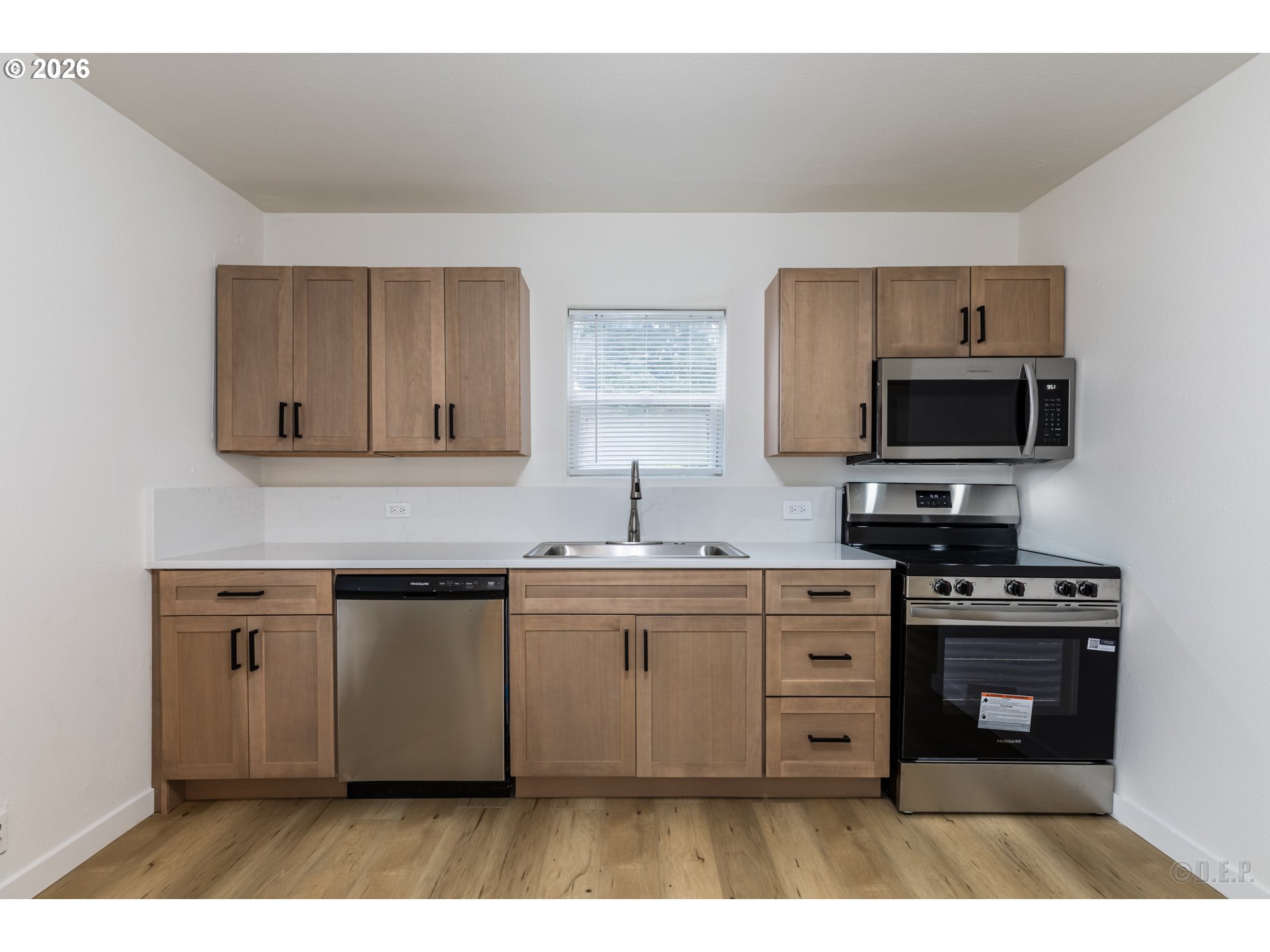 415 North 9th Street St. Helens, OR 97051 - Photo 7 of 21 a kitchen with stainless steel appliances a stove a sink and a microwave