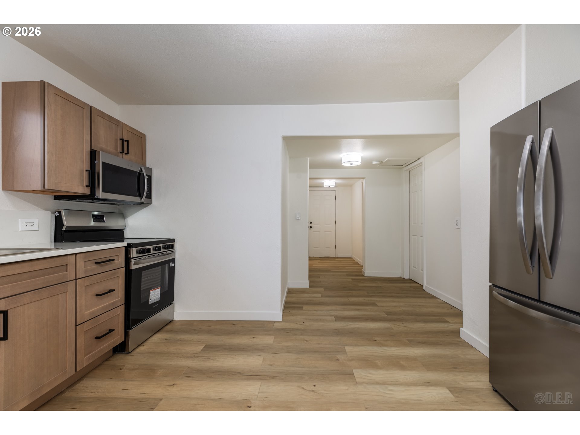 415 North 9th Street St. Helens, OR 97051 - Photo 8 of 21 a kitchen with stainless steel appliances granite countertop a refrigerator a stove a sink and a microwave