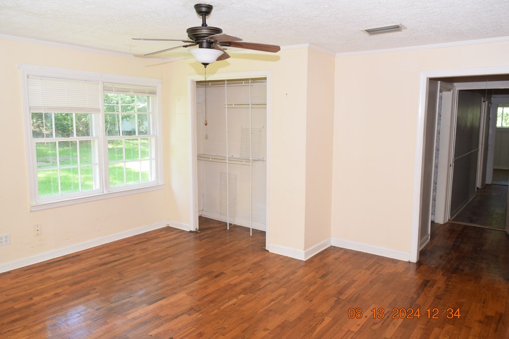 511 Chafin Drive Manchester, GA 31816 - Photo 7 of 16 a view of an empty room with wooden floor and a window