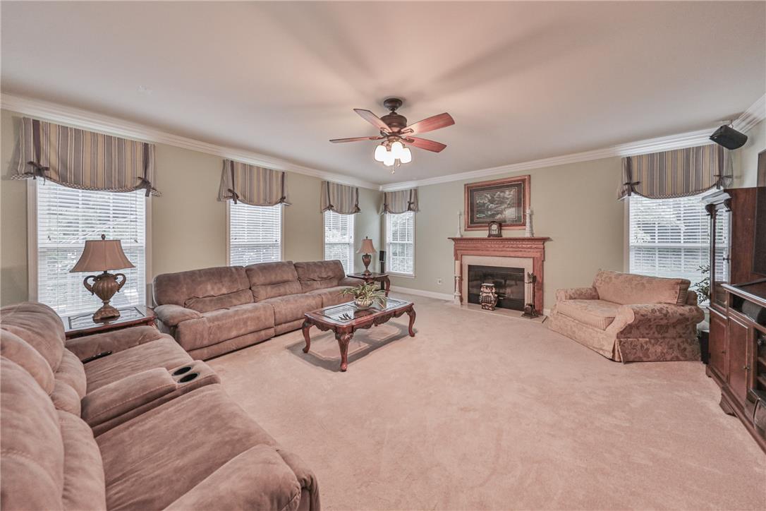138 Clover Hollow Road Easton, PA 18045 - Photo 30 of 95 A comforting living space features a warm fireplace and crown molding, setting a serene tone.