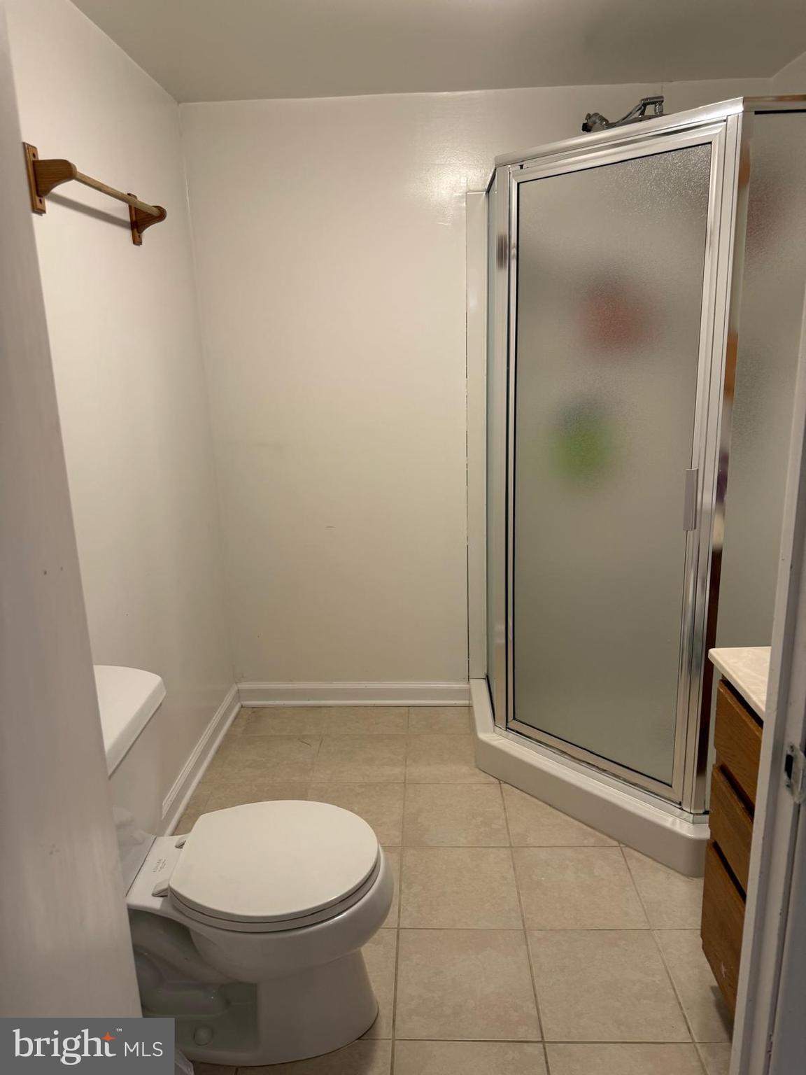 229 Old Line Avenue Laurel, MD 20724 - Photo 24 of 42 a bathroom with a granite countertop toilet and a shower