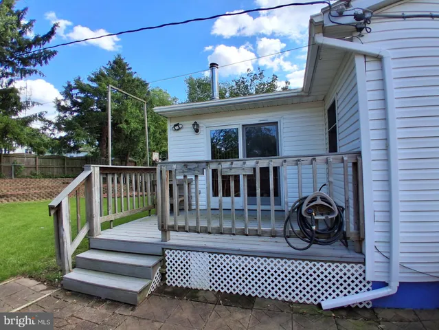 a view of a backyard with a garden and trees