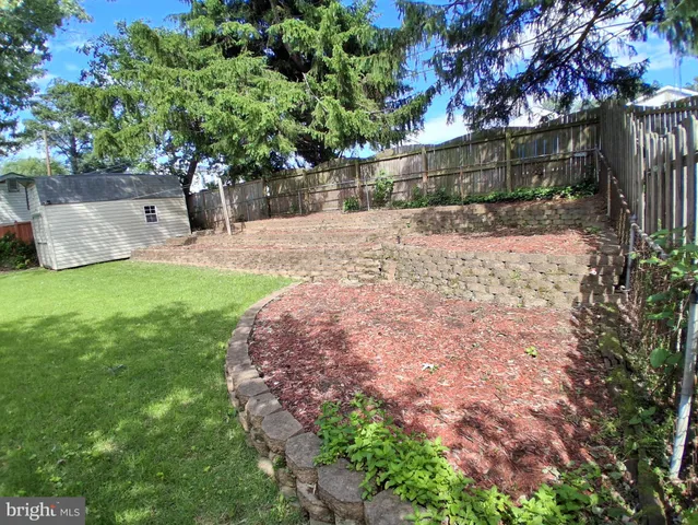 a view of a house with a yard and a garden