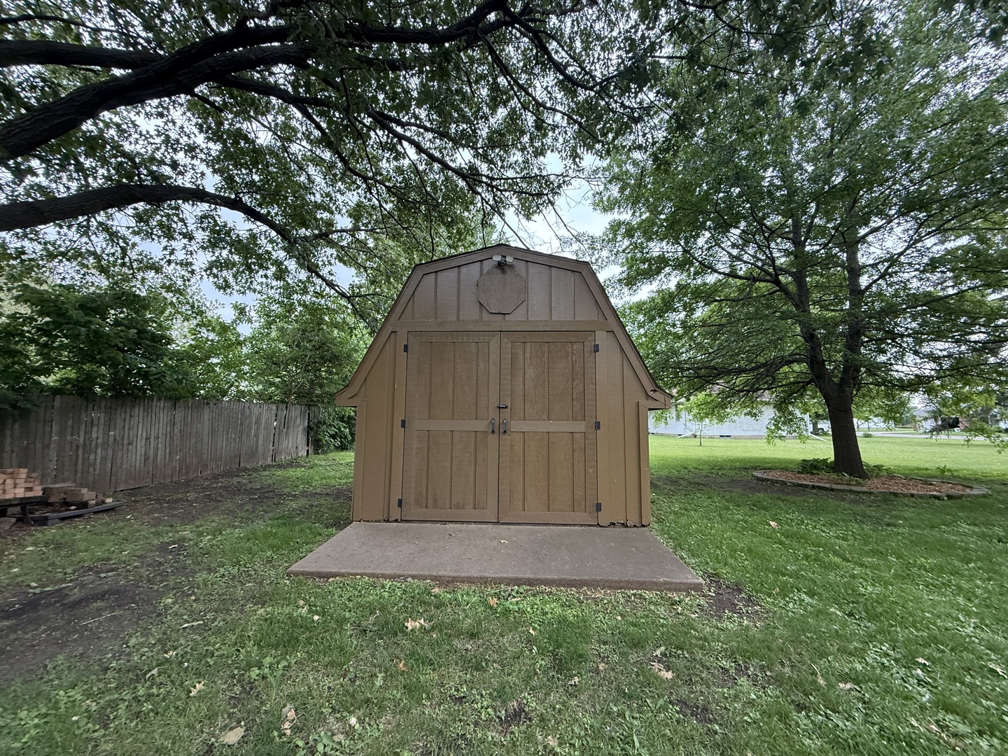 1048 Warren Street Henry, IL 61537 - Photo 26 of 26 a view of backyard with large trees and wooden fence