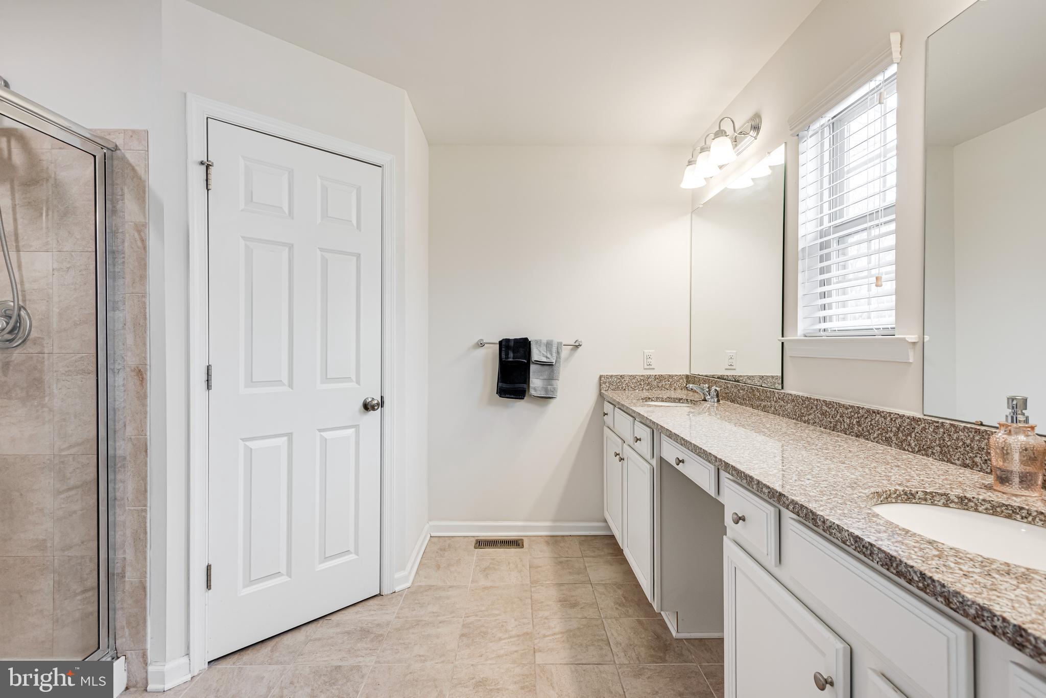35 Addison Lane Malvern, PA 19355 - Photo 20 of 42 a bathroom with a granite countertop sink and a mirror