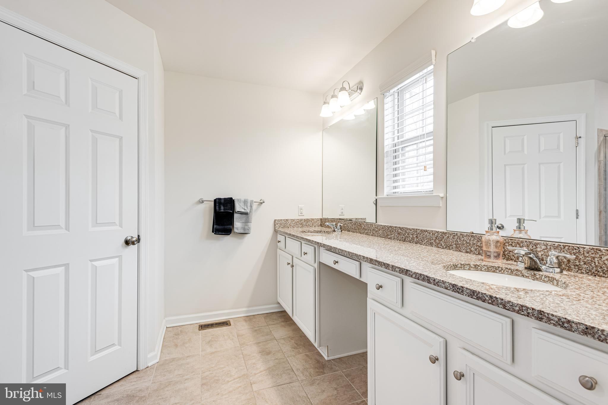 35 Addison Lane Malvern, PA 19355 - Photo 21 of 42 a bathroom with a granite countertop sink and a mirror