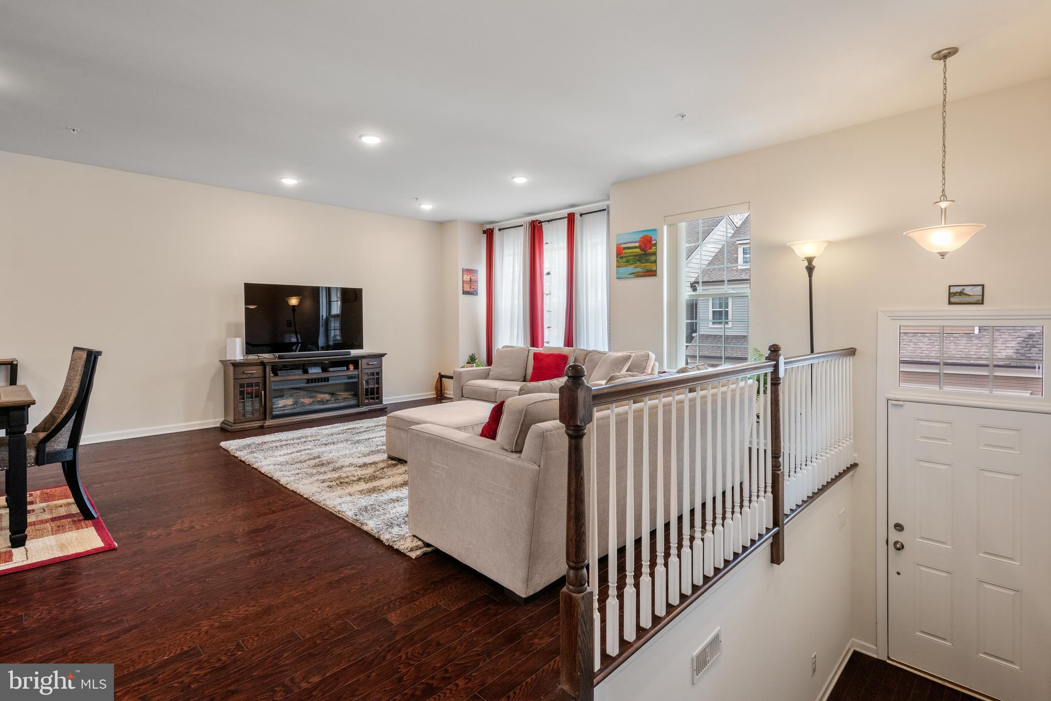 35 Addison Lane Malvern, PA 19355 - Photo 3 of 42 a living room with furniture a flat screen tv and a refrigerator