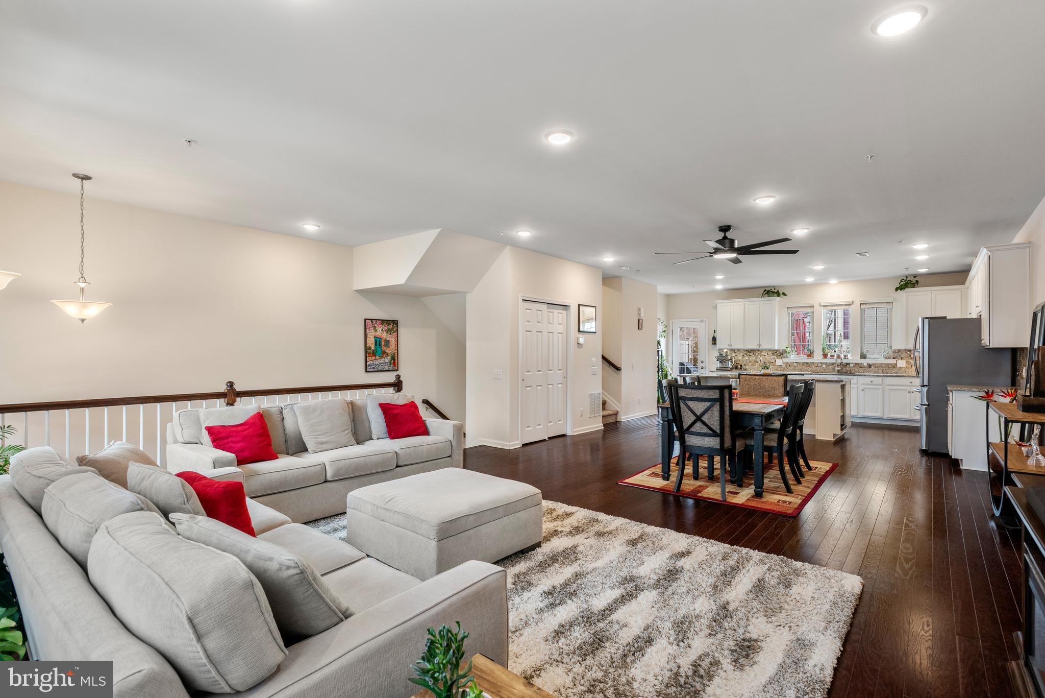 35 Addison Lane Malvern, PA 19355 - Photo 41 of 42 a living room with furniture and a dining table with wooden floor