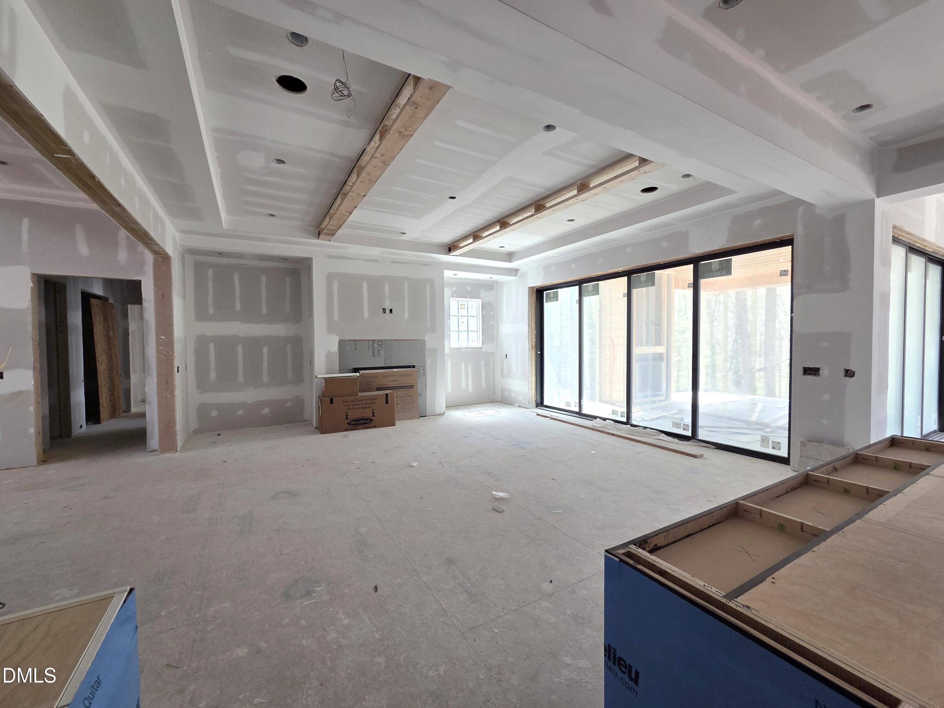 6477 Sanctuary Falls Drive Raleigh, NC 27614 - Photo 12 of 49 a view of an empty room with a window and fireplace