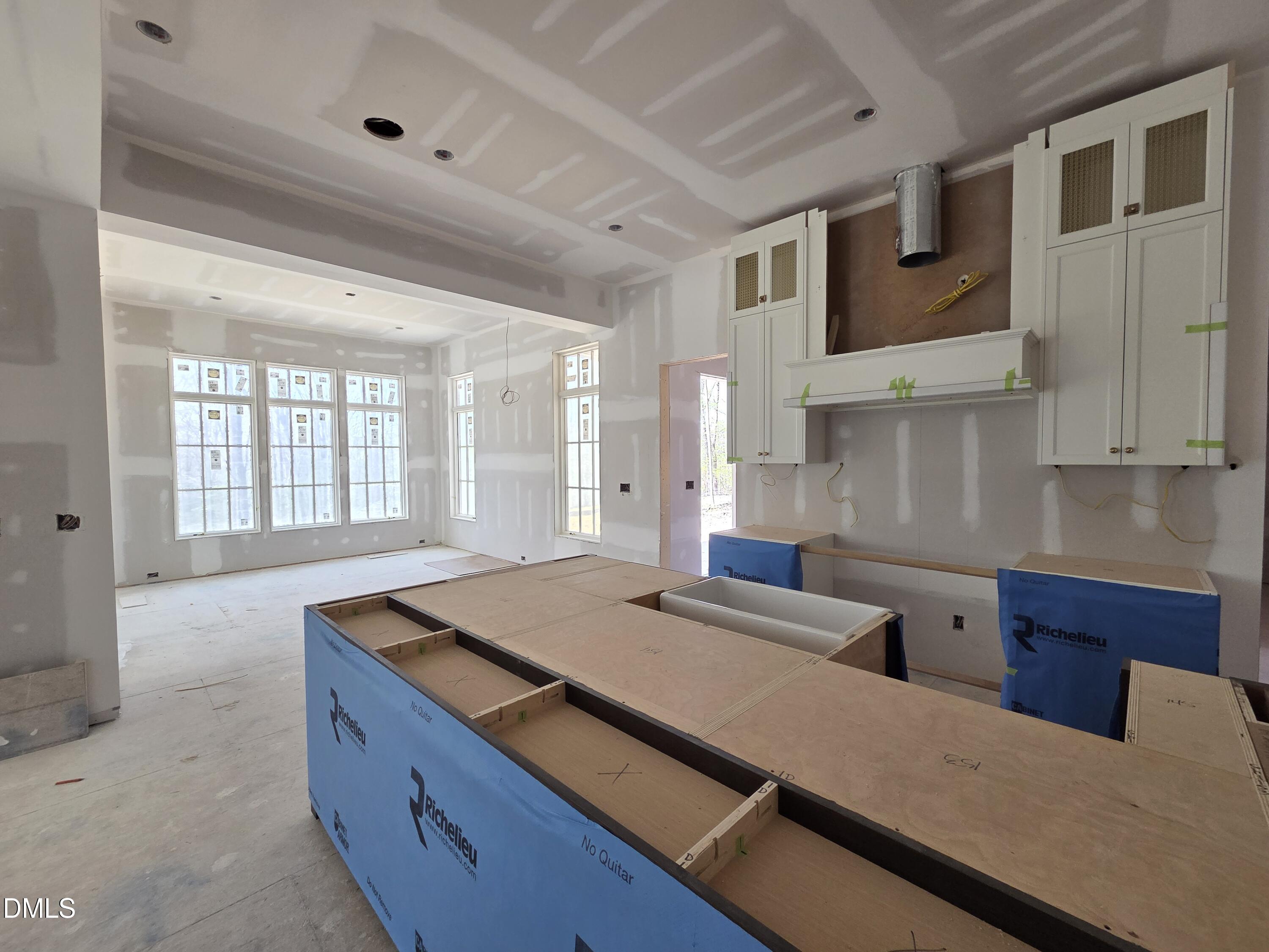 6477 Sanctuary Falls Drive Raleigh, NC 27614 - Photo 13 of 49 a living room with stainless steel appliances kitchen island granite countertop furniture and a large window