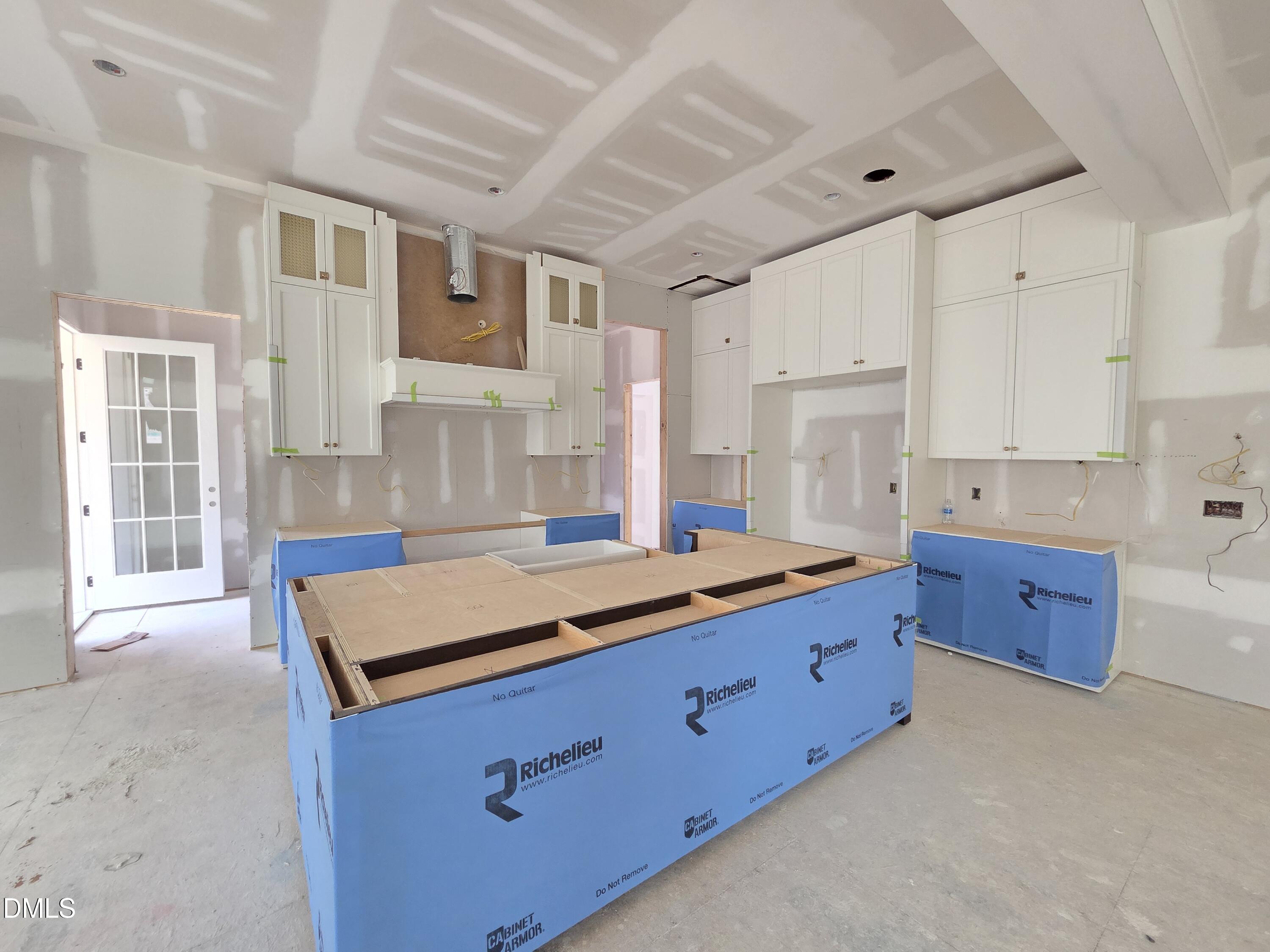 6477 Sanctuary Falls Drive Raleigh, NC 27614 - Photo 15 of 49 a kitchen with stainless steel appliances granite countertop a sink a stove and white cabinets