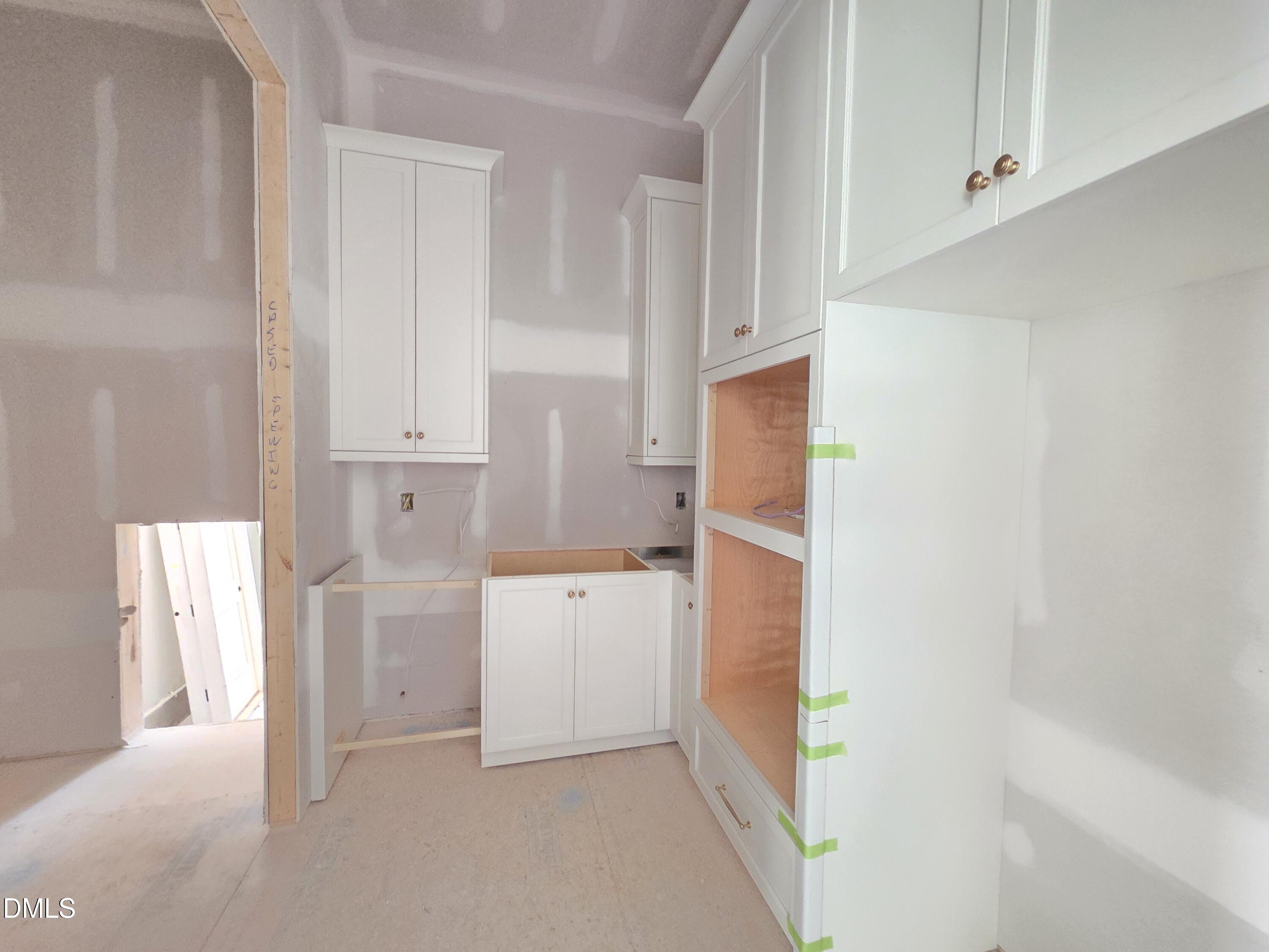 6477 Sanctuary Falls Drive Raleigh, NC 27614 - Photo 18 of 49 a kitchen with white cabinets and refrigerator