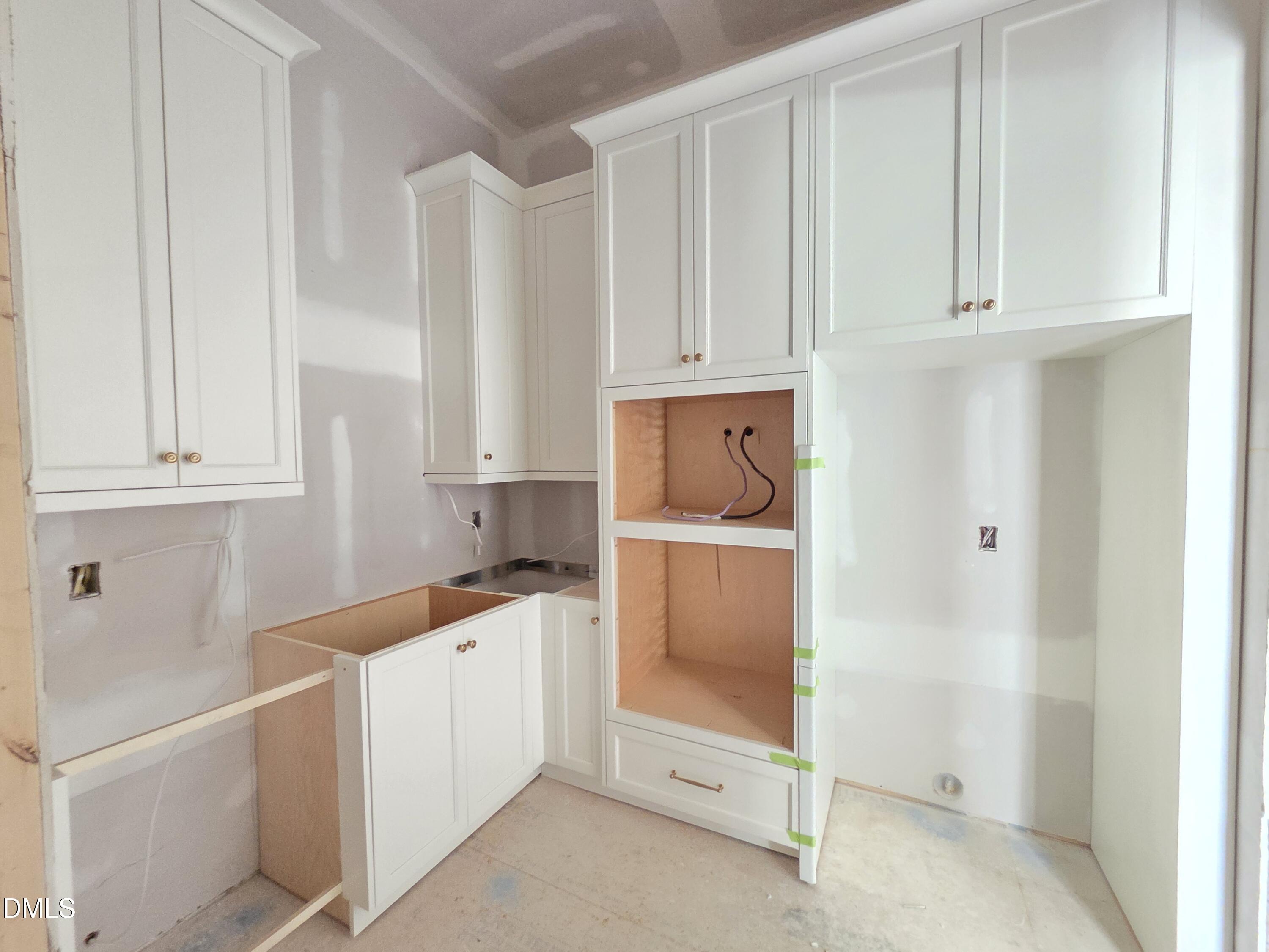 6477 Sanctuary Falls Drive Raleigh, NC 27614 - Photo 20 of 49 a utility room with cabinets washer and dryer