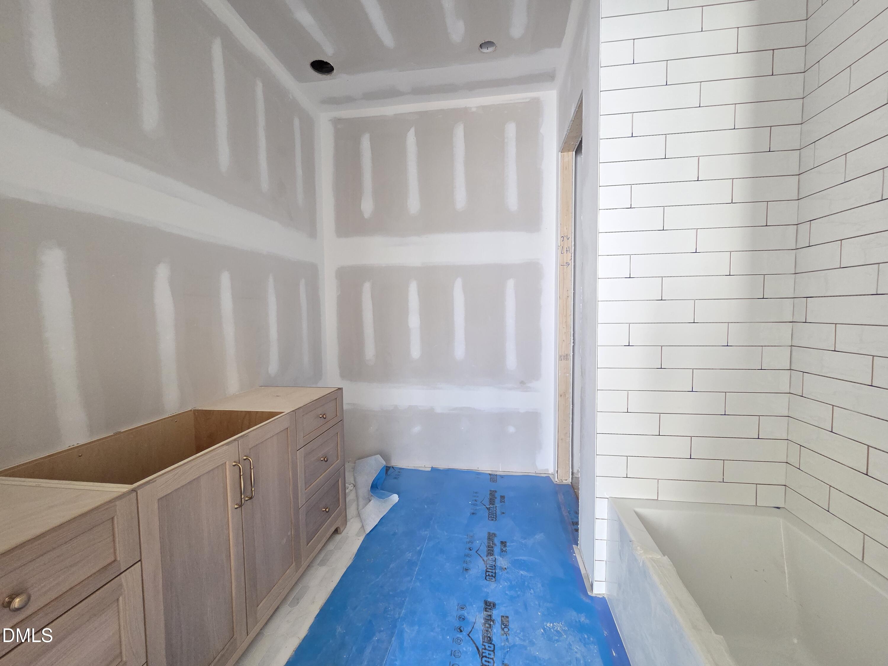 6477 Sanctuary Falls Drive Raleigh, NC 27614 - Photo 34 of 49 a bathroom with a bathtub and a shower