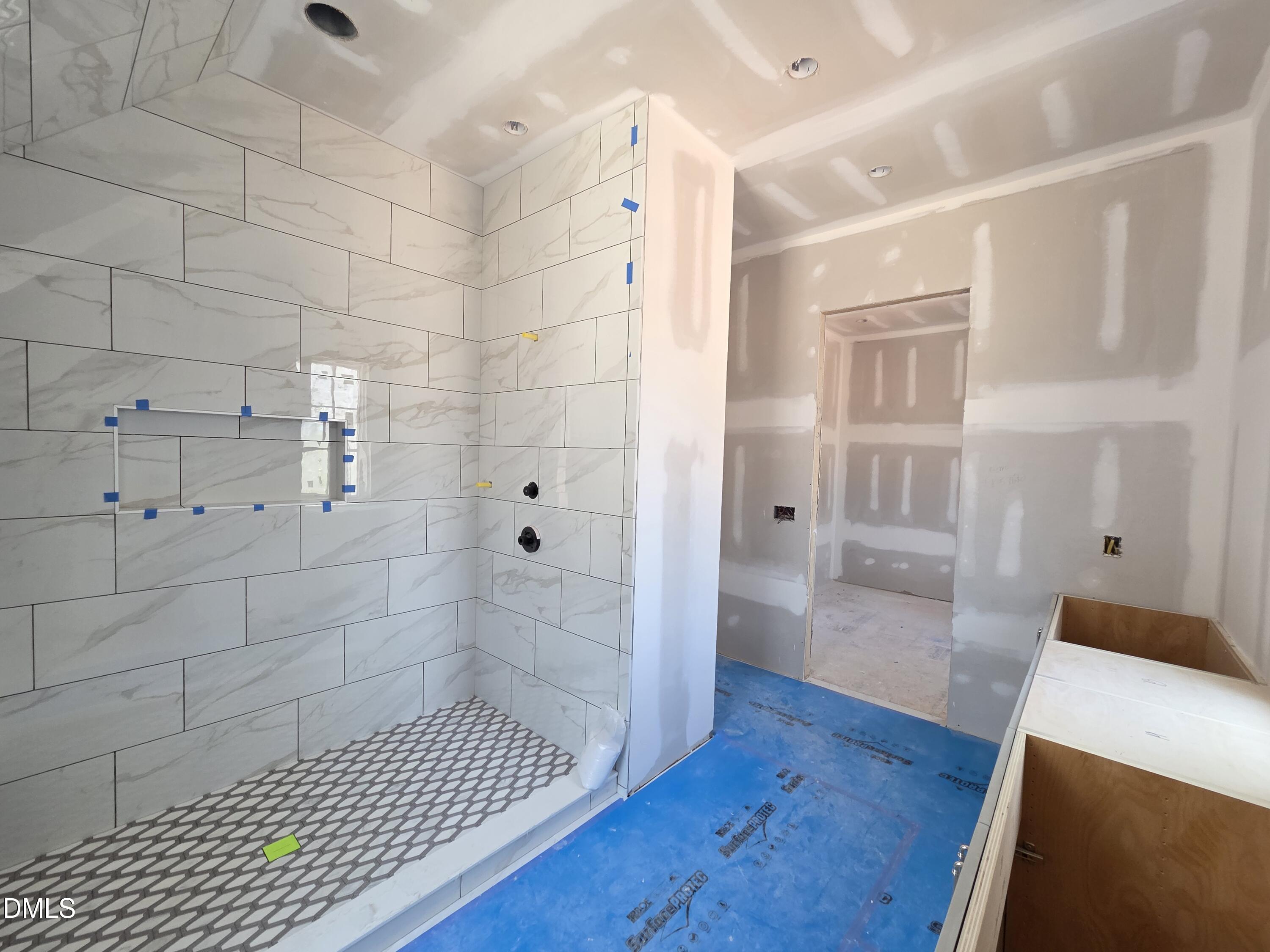 6477 Sanctuary Falls Drive Raleigh, NC 27614 - Photo 39 of 49 a bathroom with a glass shower door