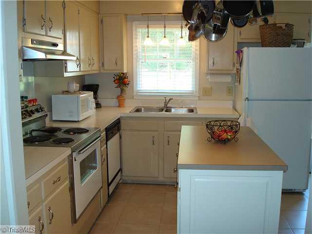 3322 Rockingham Road High Point, NC 27265 - Photo 7 of 13 Kitchen. Spacious Kitchen with center island with extra storage. Appliances include dishwasher & range/oven with exhaust fan. Beautiful updated tile flooring.