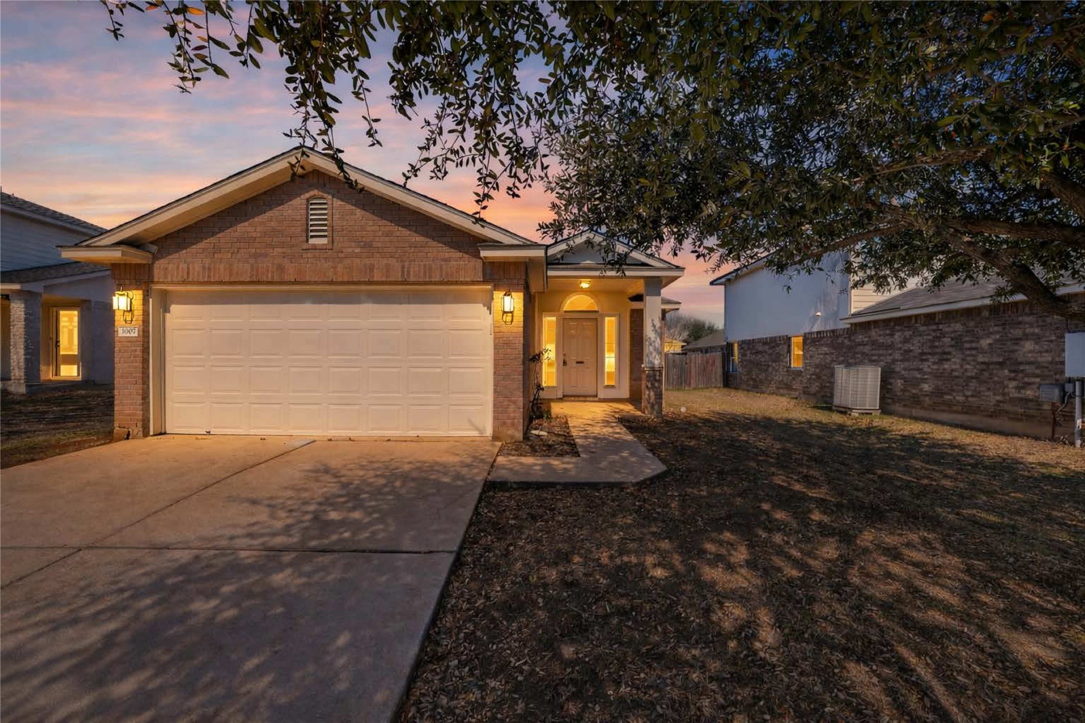 1007 Gentry Drive Leander, TX 78641 - Photo 1 of 35 a front view of a house with garden