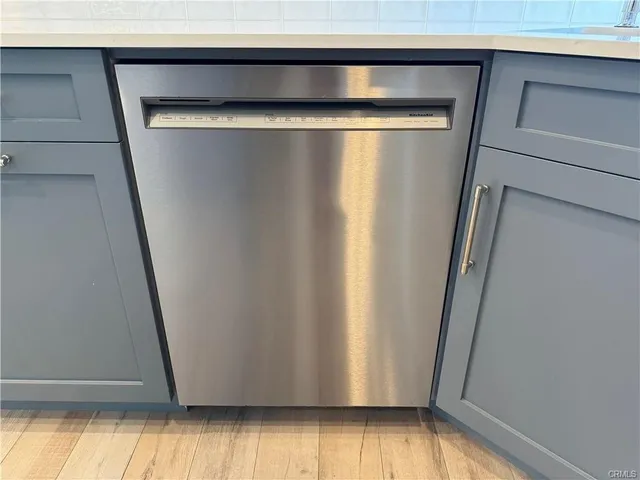 a kitchen with wooden cabinets and a stove top oven