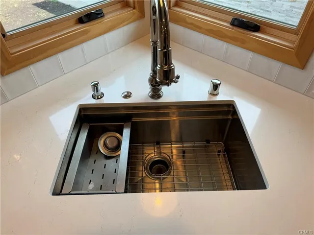 an empty room with wooden floor and entrance