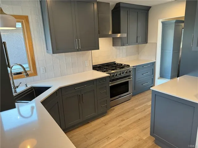 a kitchen with a sink stove and cabinets