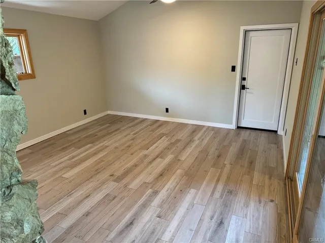 a view of a room with wooden floor and furniture