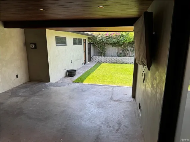 an empty room with closet and windows