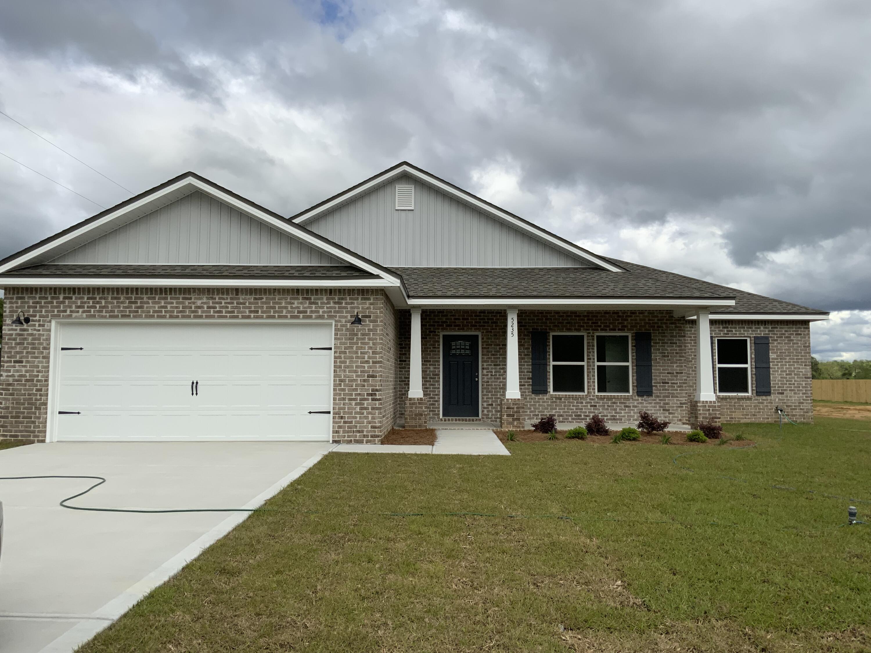 5235 Griffith Mill Road Baker, FL 32531 - Photo 1 of 10 a front view of a house with garden