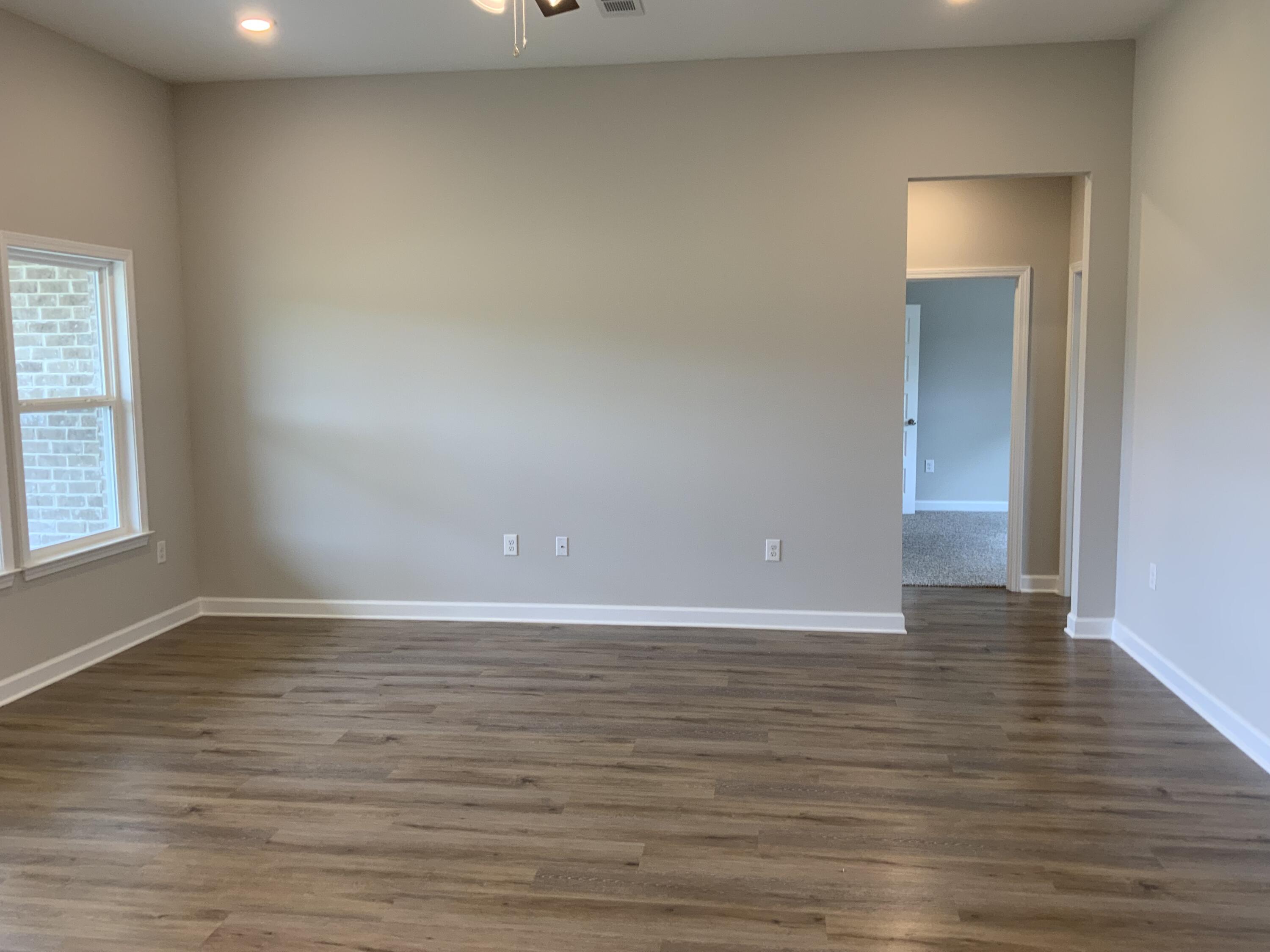 5235 Griffith Mill Road Baker, FL 32531 - Photo 3 of 10 a view of an empty room with window and wooden floor
