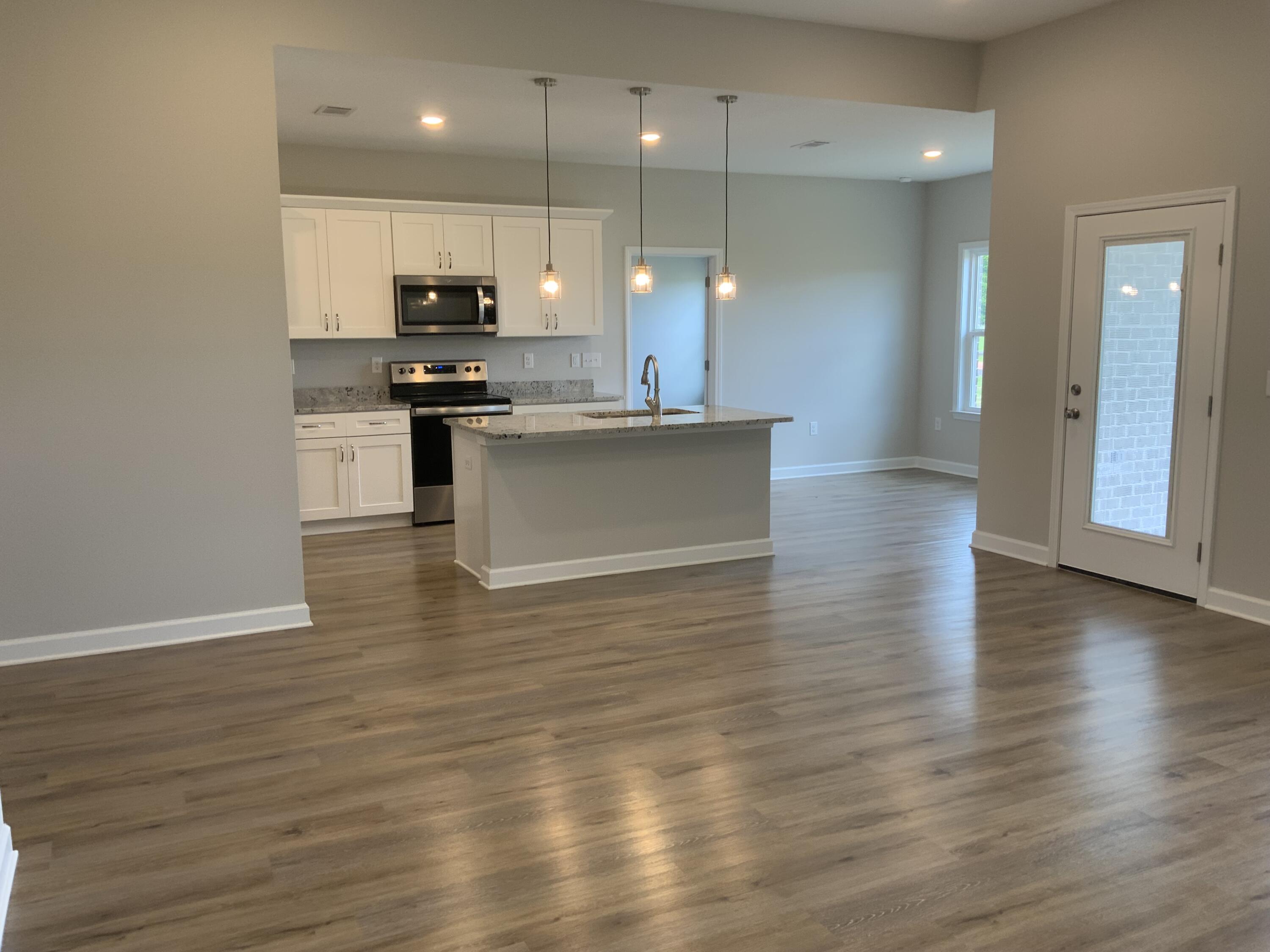 5235 Griffith Mill Road Baker, FL 32531 - Photo 4 of 10 a large kitchen with stainless steel appliances granite countertop a large counter top and a stove