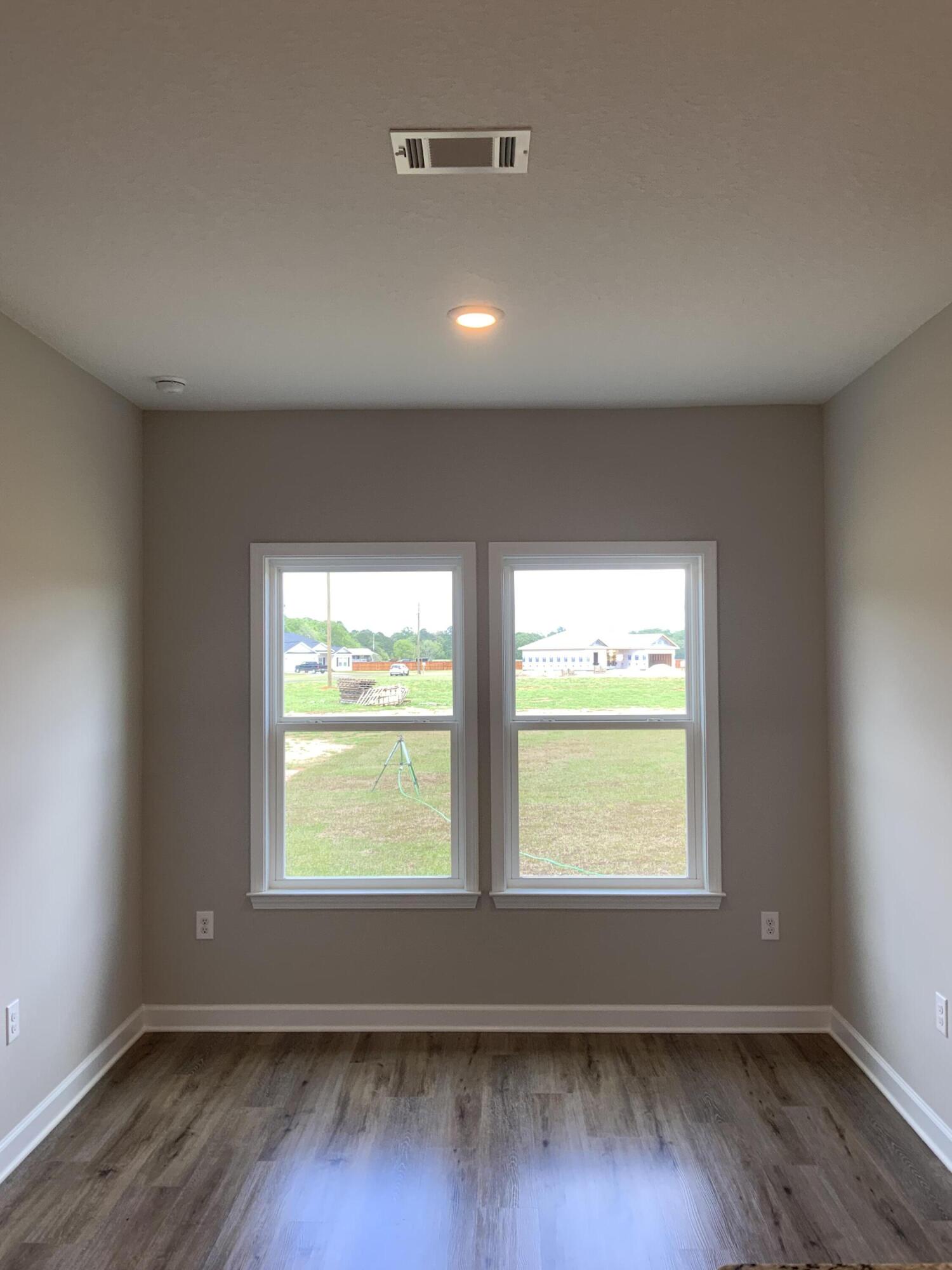 5235 Griffith Mill Road Baker, FL 32531 - Photo 5 of 10 a view of an empty room with wooden floor and a window