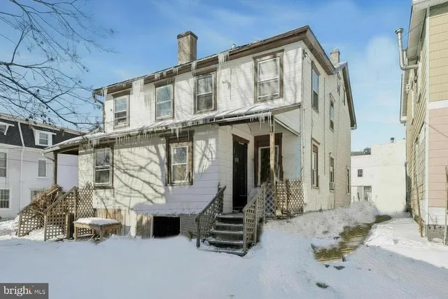 a bedroom with furniture and a flat screen tv
