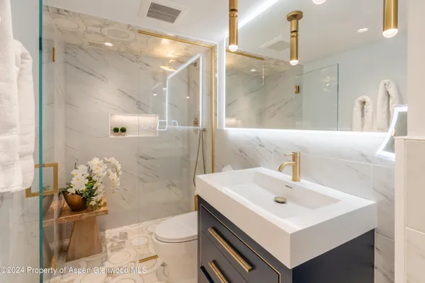 a bathroom with a sink toilet and shower