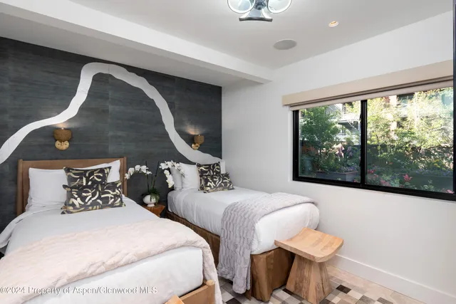 a bedroom with bed and a large window