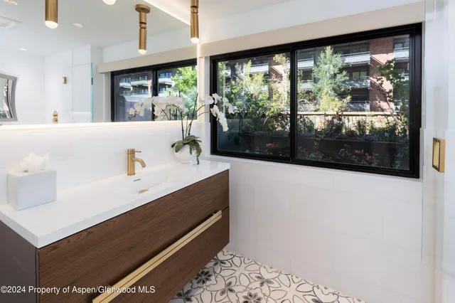 a view of bathroom with sink and mirror