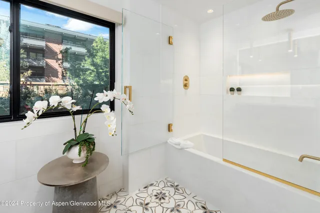 a bath room with a bathtub and a shower