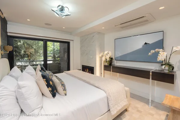 a bedroom with a bed and a large mirror