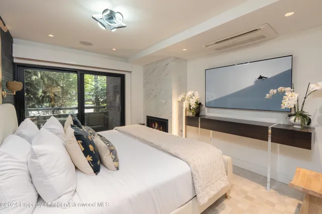 a bedroom with a bed and a large mirror