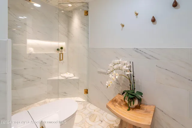 a bathroom with a granite countertop sink a mirror and vanity