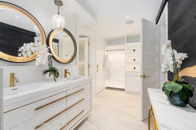 a spacious bathroom with a double vanity sink and a mirror