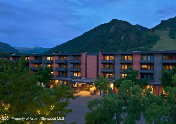 a front view of a residential apartment building with a yard