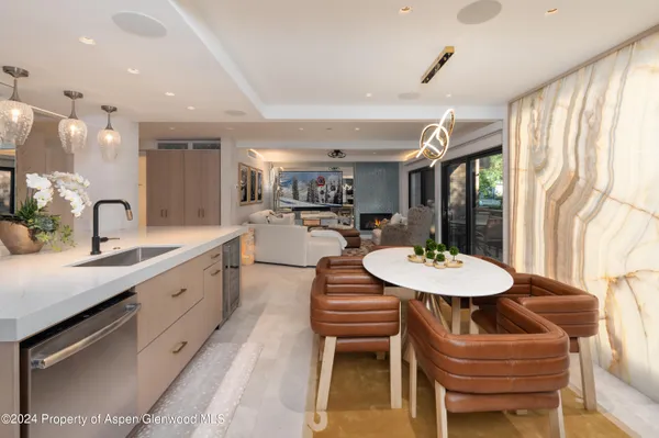 a large kitchen with a table and chairs