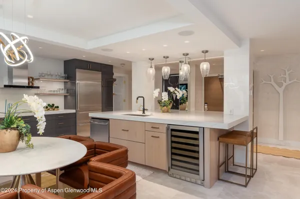 a kitchen with a table chairs sink and cabinets