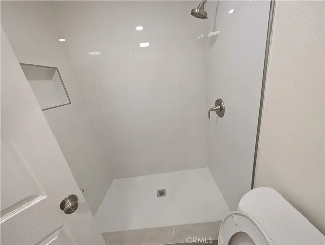 a bathroom with a tub and toilet