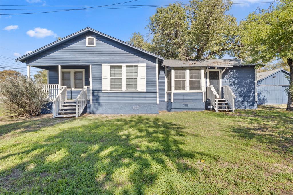 1202 East 29th Street, Unit A Austin, TX 78722 - Photo 2 of 22 Bungalow-style home featuring a front yard, an outbuilding, and covered porch